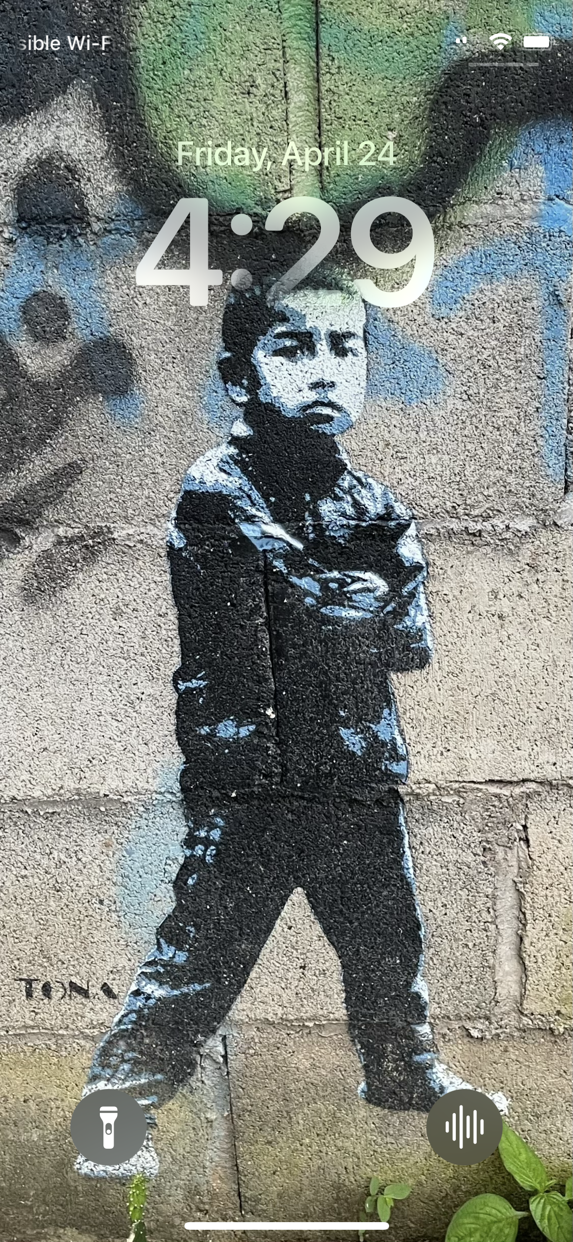 iPhone Lock Screen with Voice Memos set as the bottom right button.